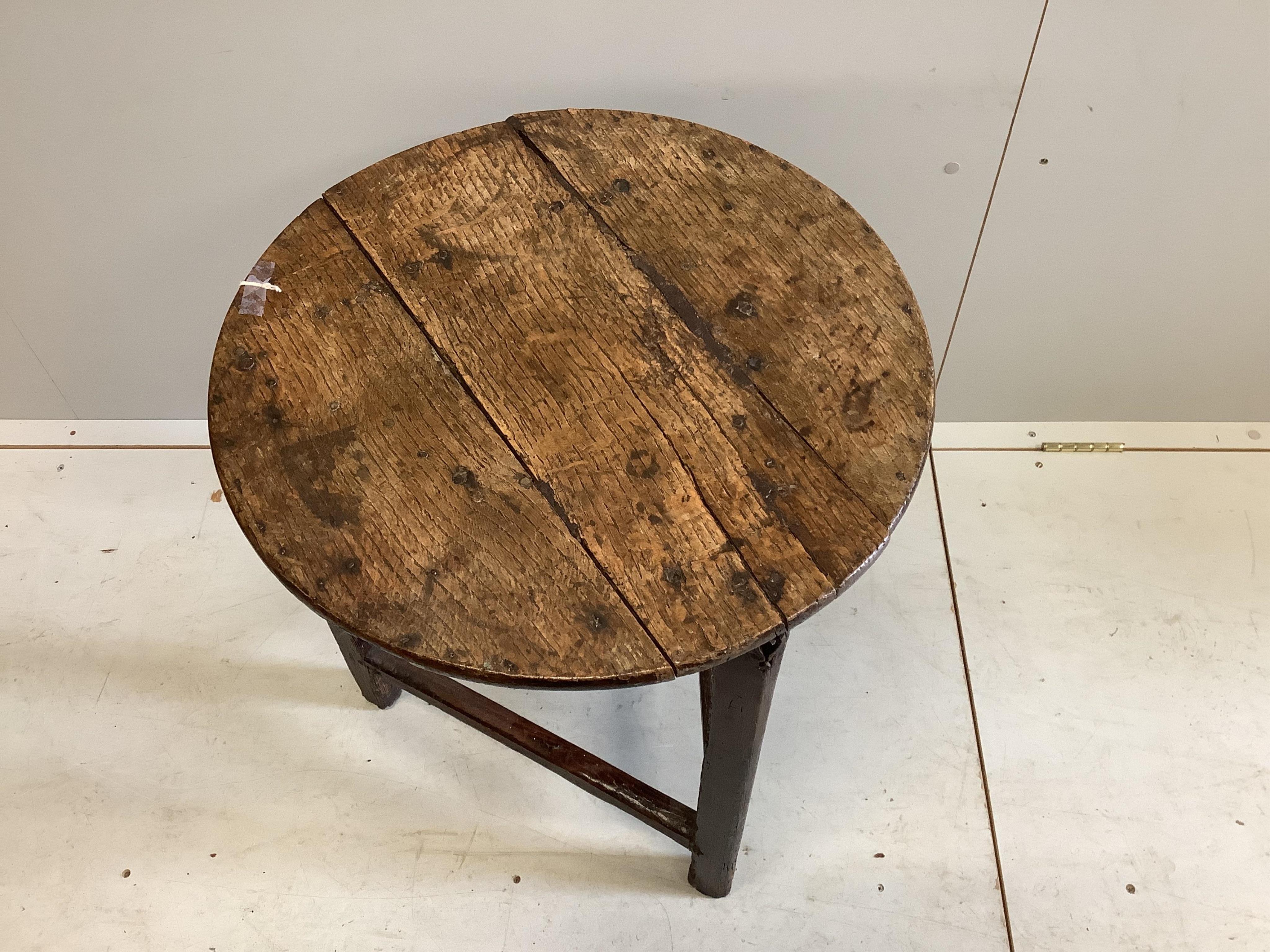 An 18th century circular oak and pine cricket table, diameter 57cm, height 63cm, together with an 18th century oak and fruitwood dining chair. Condition - poor to fair